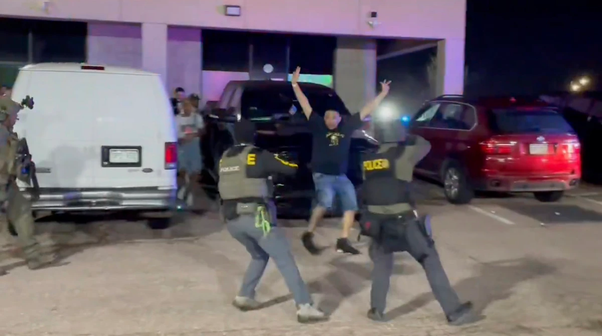 In this image taken from video released by the US Drug Enforcement Administration, officers stop a patron from a nightclub where a raid occurred Sunday, April 27, 2025, in Colorado Springs, Colo. (US Drug Enforcement Administration via AP)