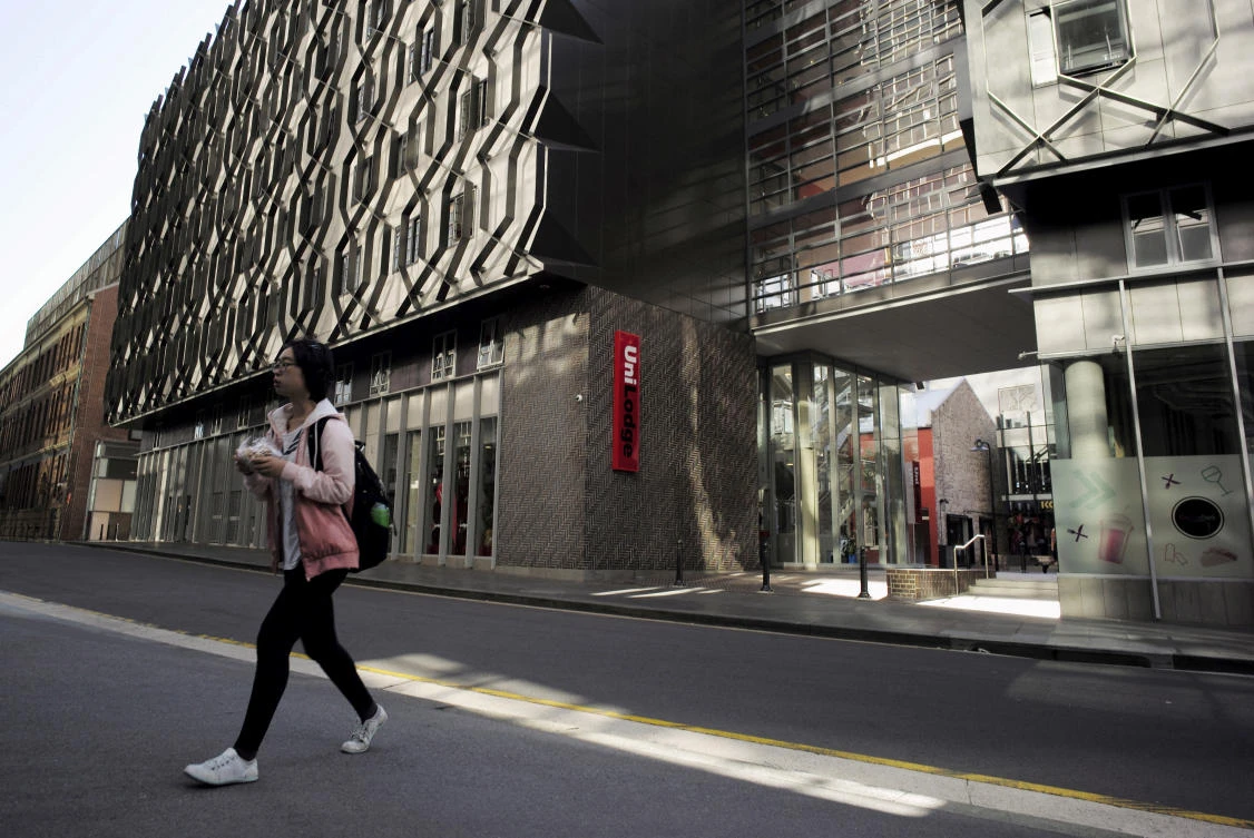 Above, a student walks from high density housing near the campus of the University of Technology in Sydney. There were more than a million international students enrolled in Australia in 2024, while 572,000 students commenced their studies. (Reuters)