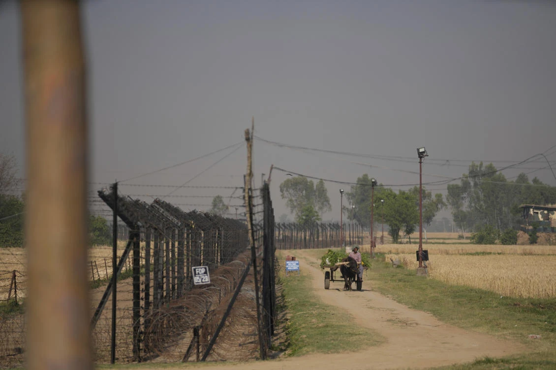 Above, an Indian farmer carries harvested cattle feed on a horse cart near fencing at the India-Pakistan international border in Ranbir Singh Pora, outskirts of Jammu on April 28, 2025. (AP)