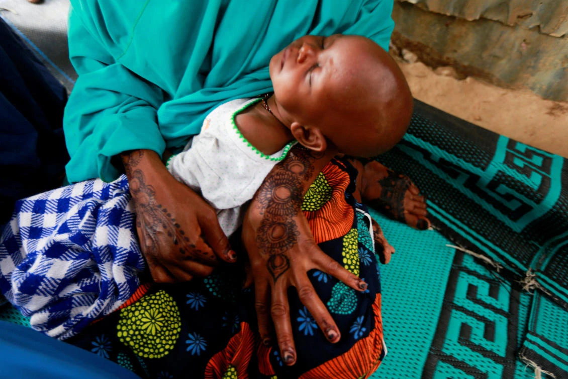 A mother carries her sleeping baby at the Gubio camp in Maiduguri, Nigeria. (AFP/File)