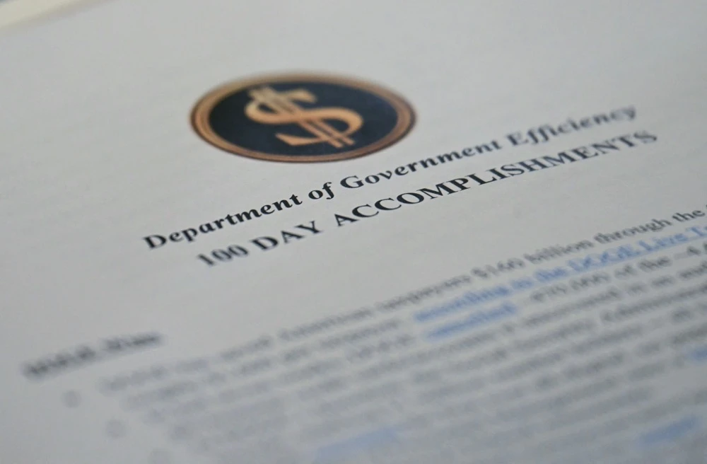 A report from the Department of Government Efficiency (DOGE) is seen as US President Donald Trump holds a meeting with his Cabinet. (AFP)
