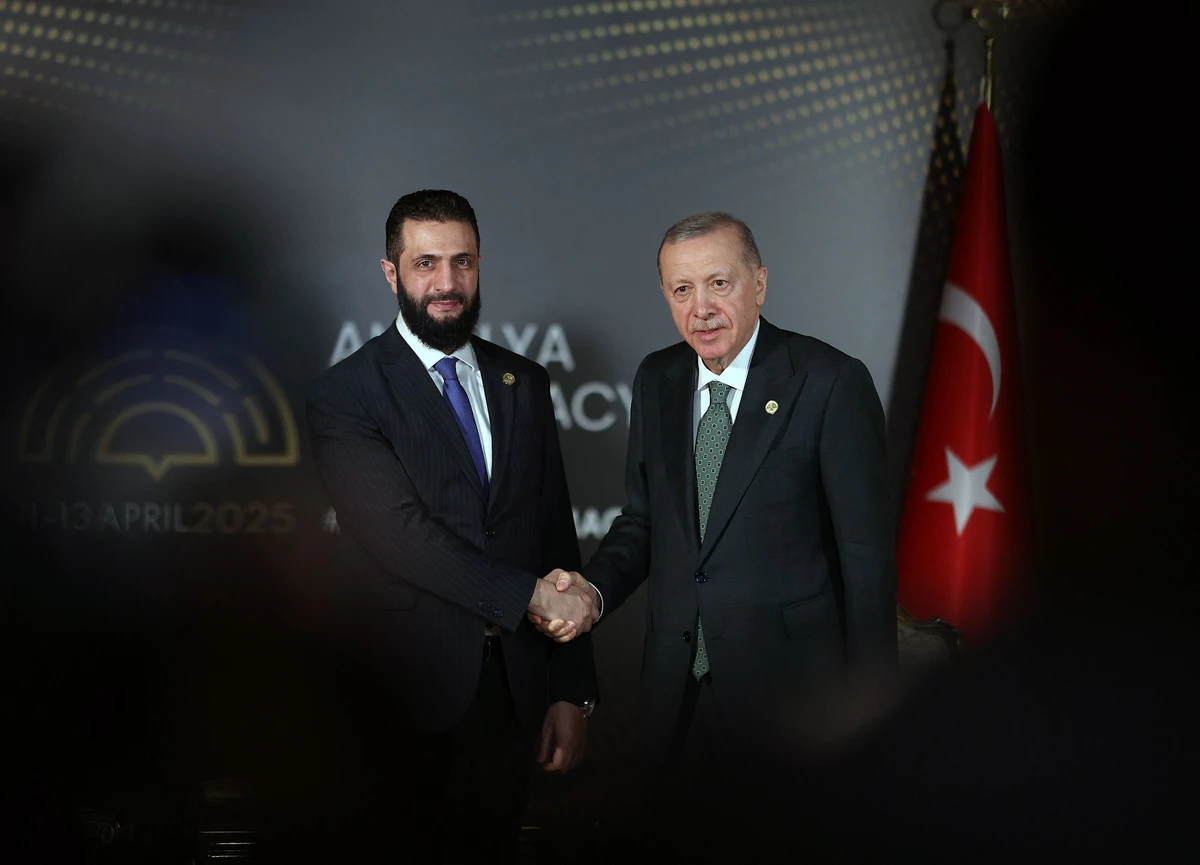 Turkey's President Erdogan shakes hands with Syria's interim President Ahmed Al-Sharaa at the Antalya Diplomacy Forum. (AFP)