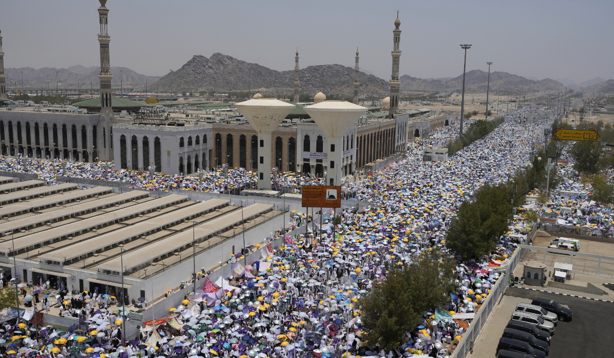 Muslim pilgrims use umbrellas to shade themselves from the sun as they gather outside Nimrah Mosque in Arafat. (AP)