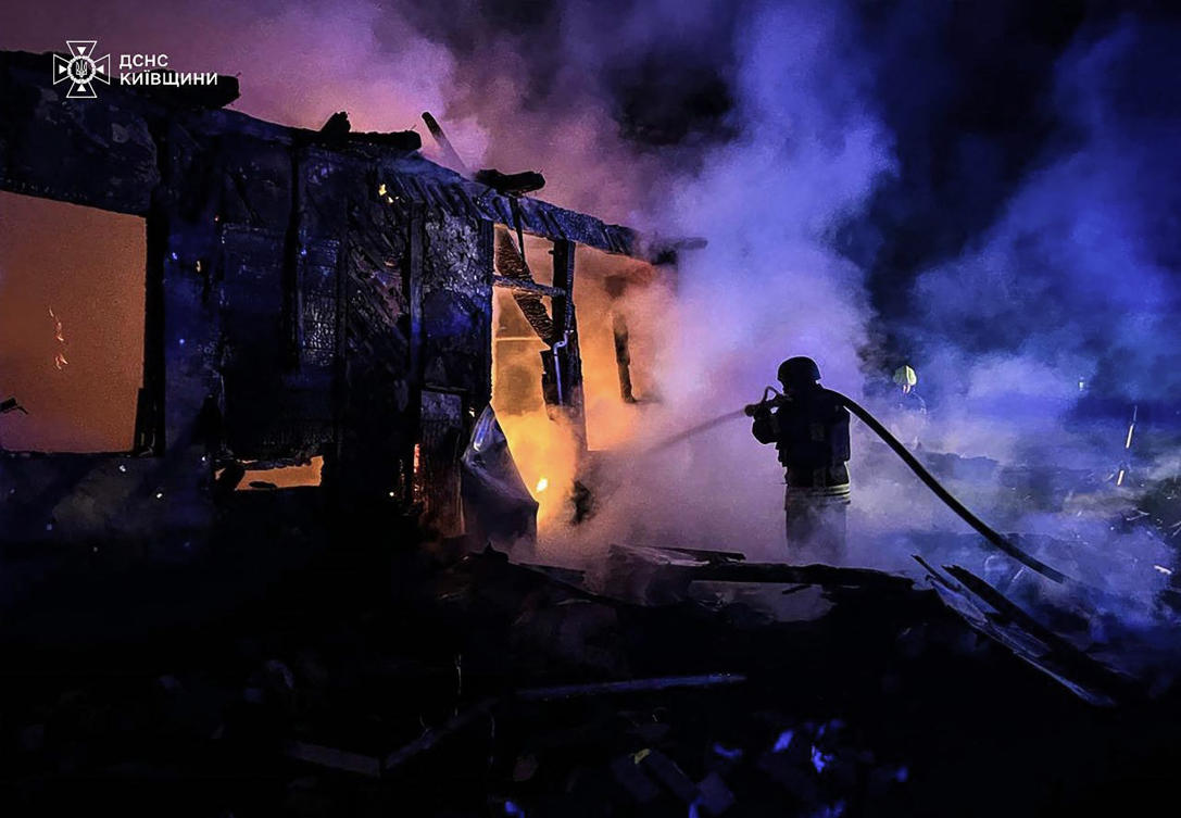 A Ukrainian firegighter extinguishing a fire at the site of a Russian drone attack in Kyiv. (File/AFP)