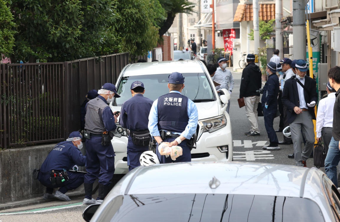 Police officers investigate the scene in Osaka's Nishinari district after a man was arrested after allegedly ploughing his car into seven schoolchildren in a suspected deliberate attack. (File/AFP)
