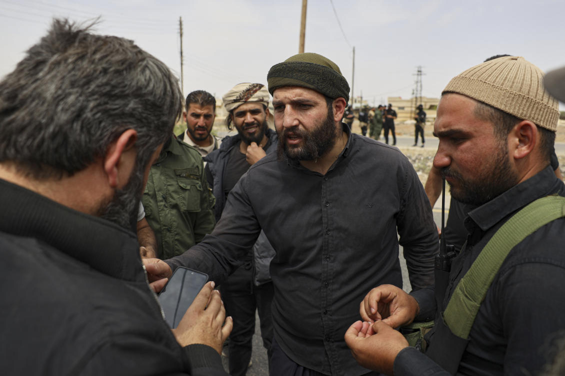 Sheikh Laith al-Balous, centre, a Druze leader in the southern Sweida province, speaks with Sweida governor Mustafa al-Bakour, left, at a highway where they found bodies of Syrian Druze fighters, on Thursday, May 1, 2025. (AP)