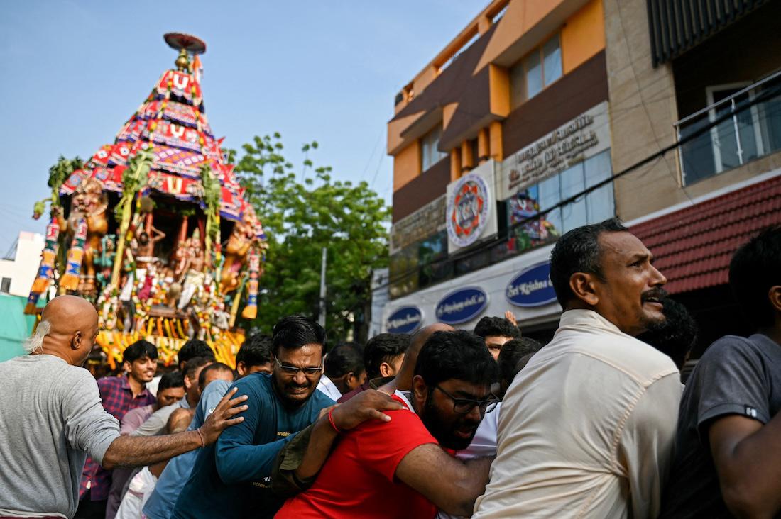 Hindu devotees pull a chariot as they take part in a religious procession during the chariot festival. (File/AFP)