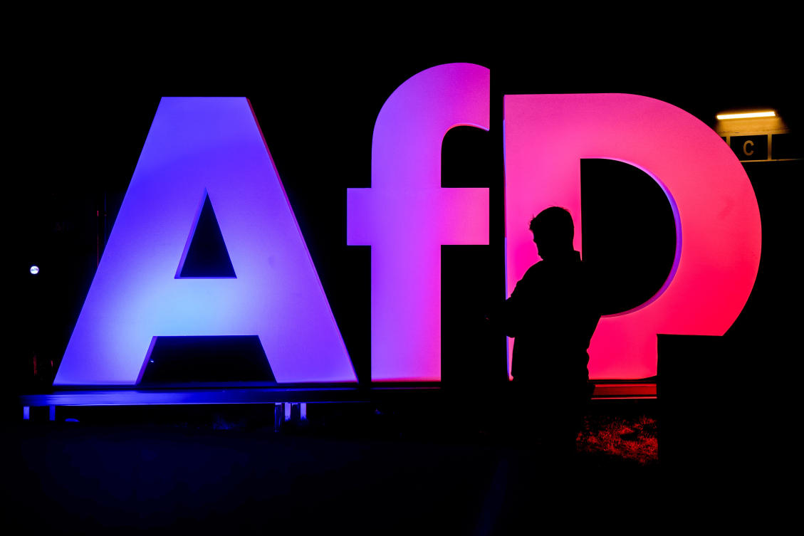 A man stands in front of the logo at the AfD party headquarters in Berlin, Germany, Feb. 23, 2025. (AP)