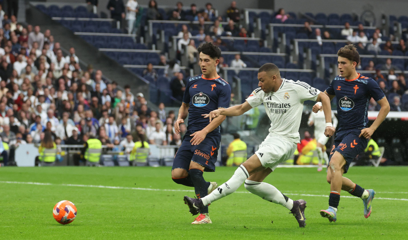 Real Madrid’s French forward Kylian Mbappe scores his team’s third goal during the Spanish league football match between Real Madrid CF and RC Celta de Vigo at Santiago Bernabeu Stadium in Madrid on Sunday. (AFP)