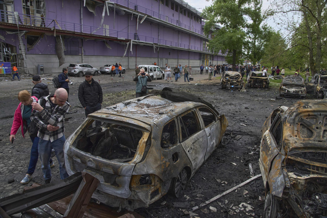 People look at their burnt cars in the residential area following Russia's drone attack in Kyiv, Ukraine, Sunday, May 4, 2025. (AP)
