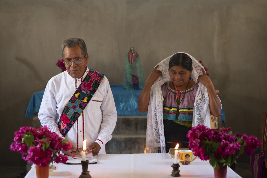 Deacon Juan, accompanied by his wife Crecencia, stands at the altar during a Mass honoring the late Pope Francis, in Simojovel, Mexico, April 27, 2025. (AP)
