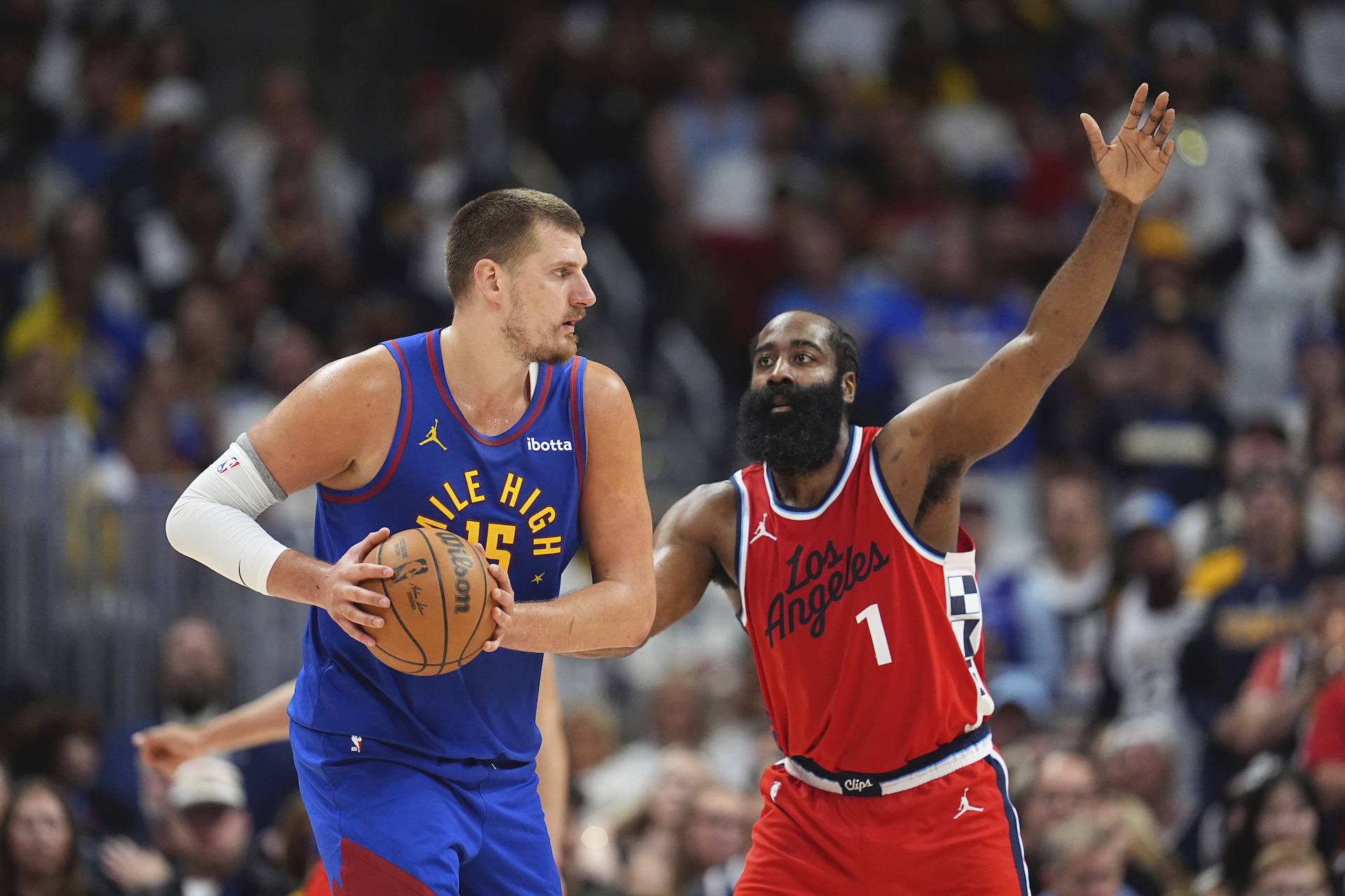 Denver Nuggets center Nikola Jokic, left, looks to pass the ball as Los Angeles Clippers guard James Harden, right, defends in the second half of Game 7 of an NBA basketball first-round playoff series Saturday, May 3, 2025, in Denver. (AP)