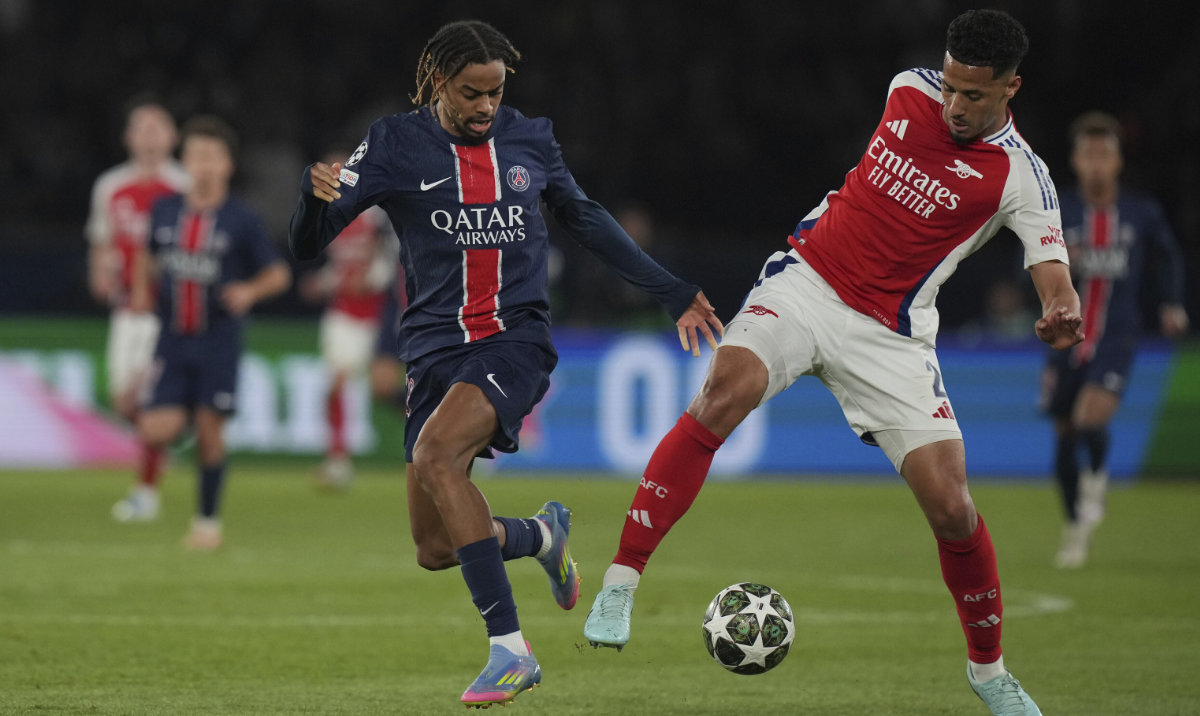 Arsenal's William Saliba, right, challenges PSG's Bradley Barcola during the Champions League semifinal, second leg soccer match between Paris Saint-Germain and Arsenal at the Parc des Princes in Paris, Wednesday, May 7, 2025. (AP)