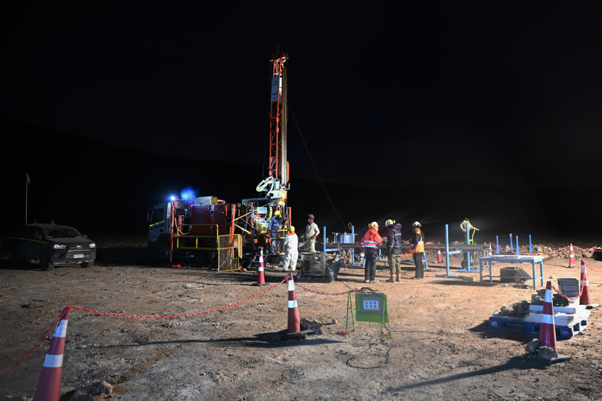 Workers operate a drilling rig at the Aguilar salt flat, located in the Andean mountain range of the Atacama Region, Chile, on May 16, 2024. (AFP)