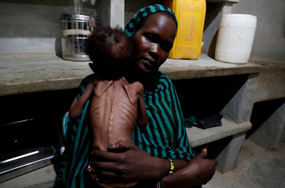 A 25-year-old mother holds her severely malnourished child at the paediatric ward of the Mother of Mercy Hospital in Gidel, South Kordofan, Sudan. (Reuters/File Photo)