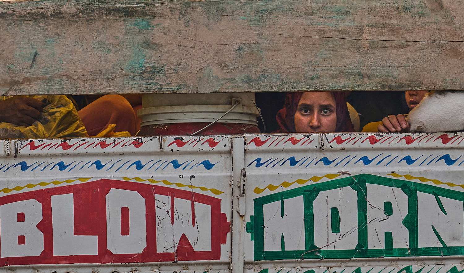 A Kashmiri woman looks from a truck as she along with her family members leave their village following overnight shelling from Pakistan at Gingal village in Uri district, Indian-administered Kashmir, on May 9, 2025. (AP)