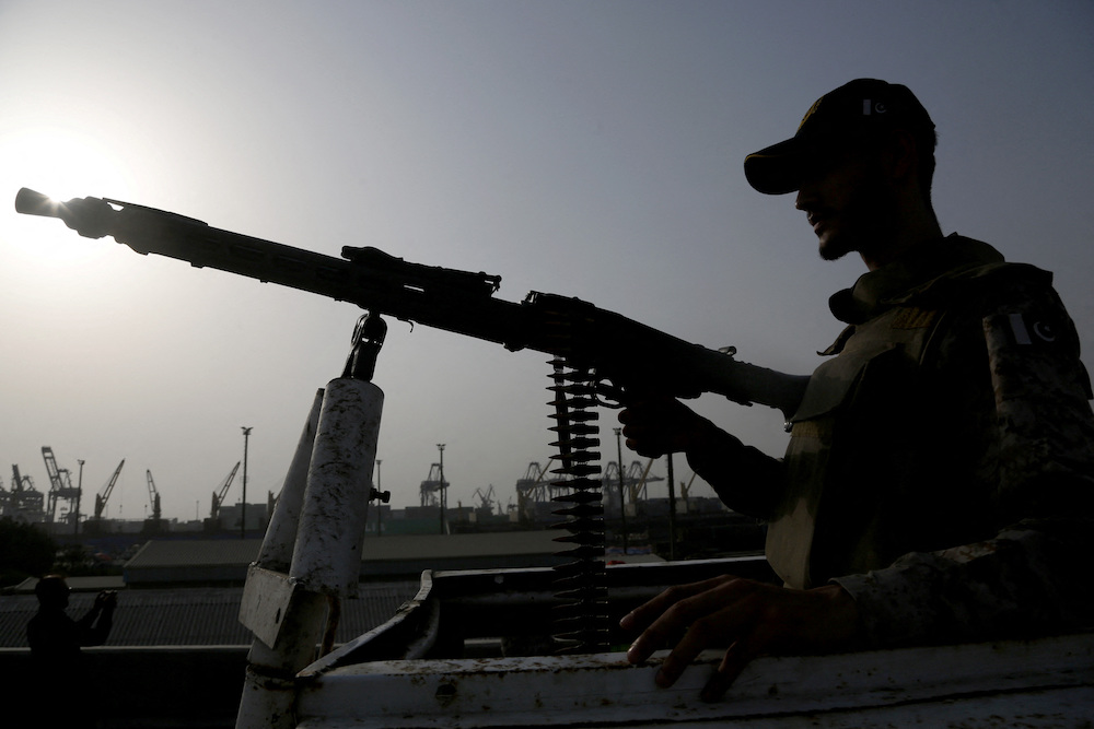 A paramilitary trooper mans a gun atop a vehicle as he keeps guard during a media tour of the Karachi Port, Pakistan, May 9, 2025. (Reuters)