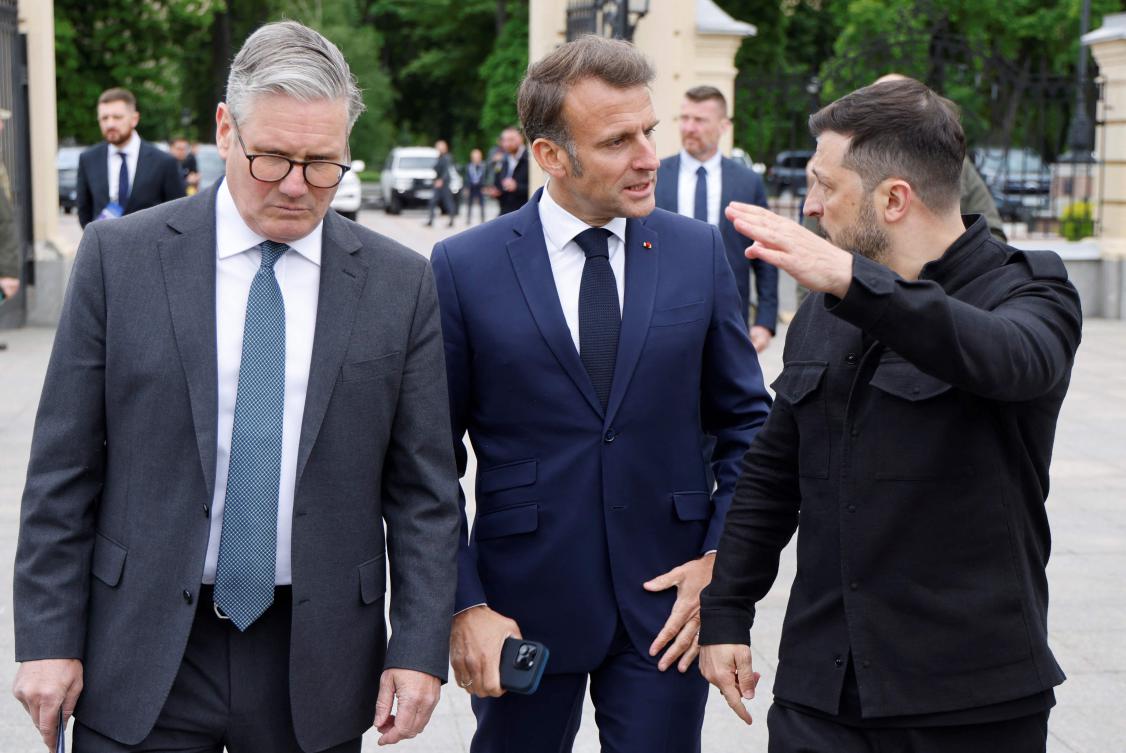 British Prime Minister Keir Starmer and French President Emmanuel Macron listen to Ukranian President Voloydmyr Zelensky as they walk in the grounds of the Mariynsky Palace in Kyiv on May 10, 2025. (AFP)