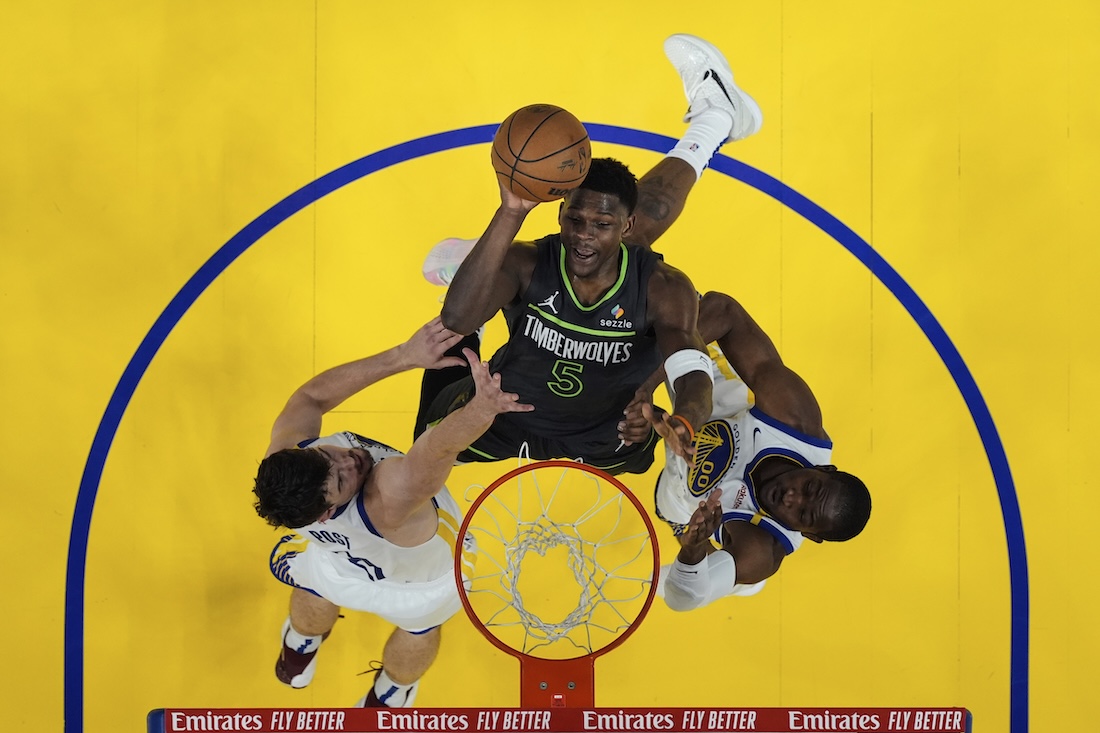 Minnesota Timberwolves guard Anthony Edwards shoots between Golden State Warriors center Quinten Post, left, and forward Jonathan Kuminga during the first half of Game 3 of an NBA basketball second-round playoff series Saturday in San Francisco. (AP)