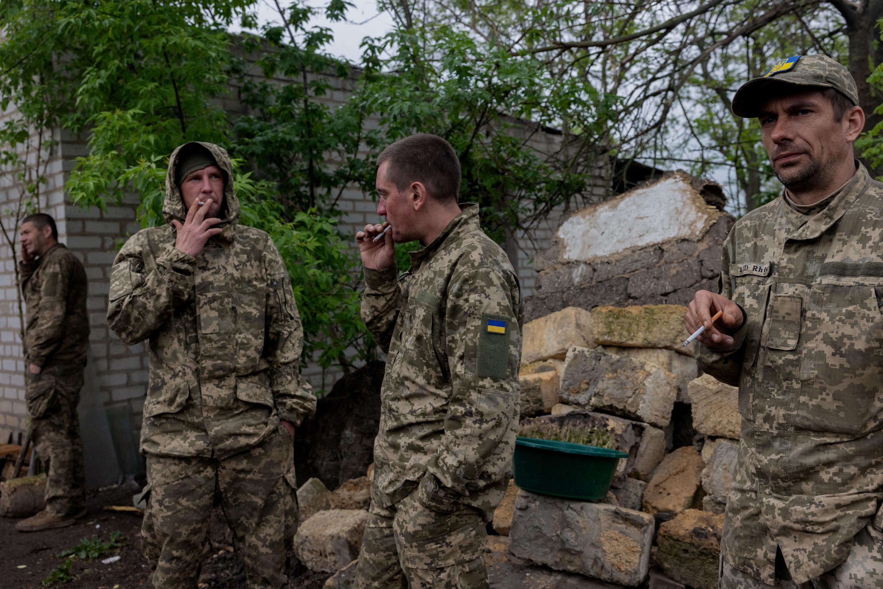 Ukrainian servicemen of the 24th Separate Assault Battalion "Aidar" smoke during a rest moment between rotations at an undisclosed location in Dnipropetrovsk Region, May 9, 2025. (AFP)
