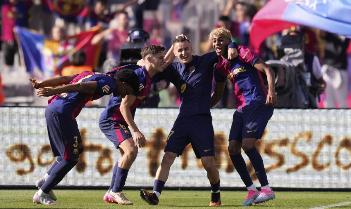 Barcelona players celebrate at the end of the Spanish La Liga soccer match between Barcelona and Real Madrid at the Lluis Companys Olympic Stadium in Barcelona, Spain, Sunday, May 11, 2025. (AP)