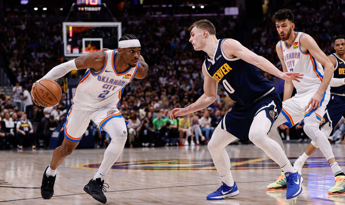 Oklahoma City Thunder guard Shai Gilgeous-Alexander (2) controls the ball as Denver Nuggets guard Christian Braun (0) guards in the second quarter during game four of the second round of the 2025 NBA Playoffs at Ball Arena. (Reuters)