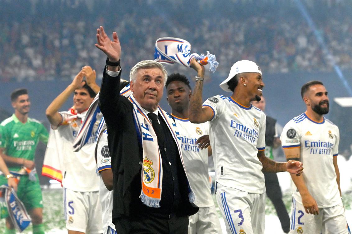Real Madrid coach Carlo Ancelotti waves as he walks on the pitch with his players during the club’s celebration of their 14th European Cup at the Santiago Bernabeu stadium, May 29, 2022. (AFP)