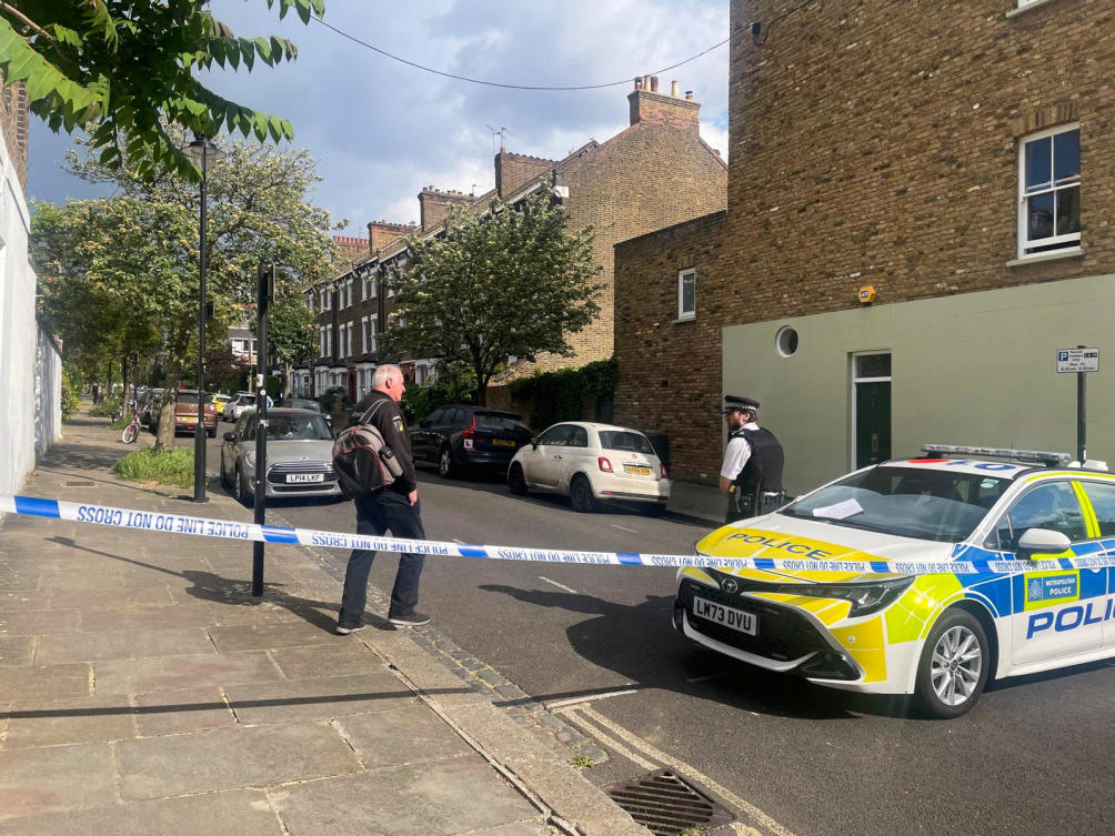 A person walks to a police officer at a cordoned off street, where a fire broke out at Britain’s Prime Minister Keir Starmer’s home in the early hours of Monday, in north London, Britain, May 12, 2025. (Reuters)