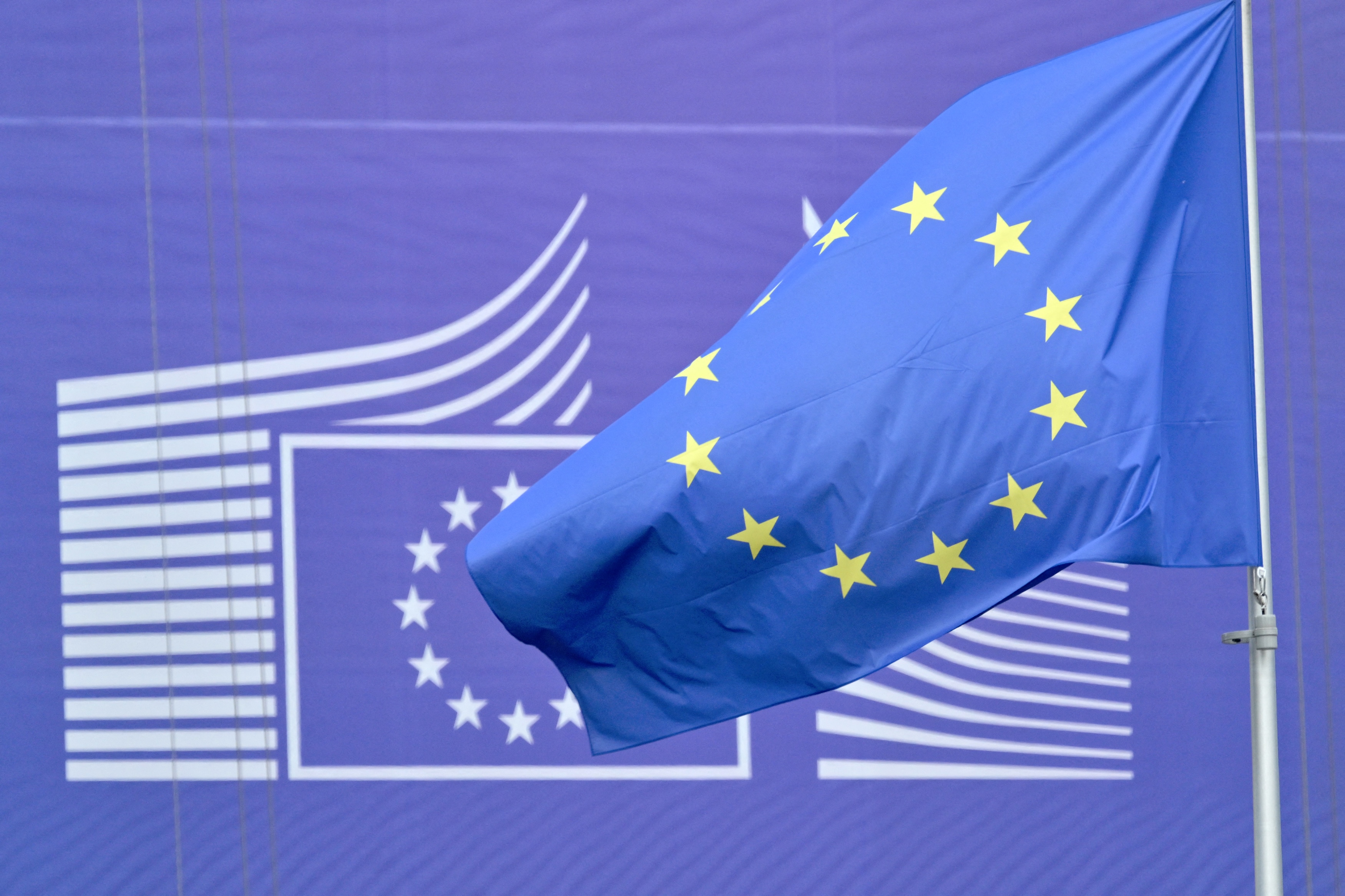 This photograph shows a European flag flying outside the EU headquarters in Brussels, May 6, 2025. (AFP)