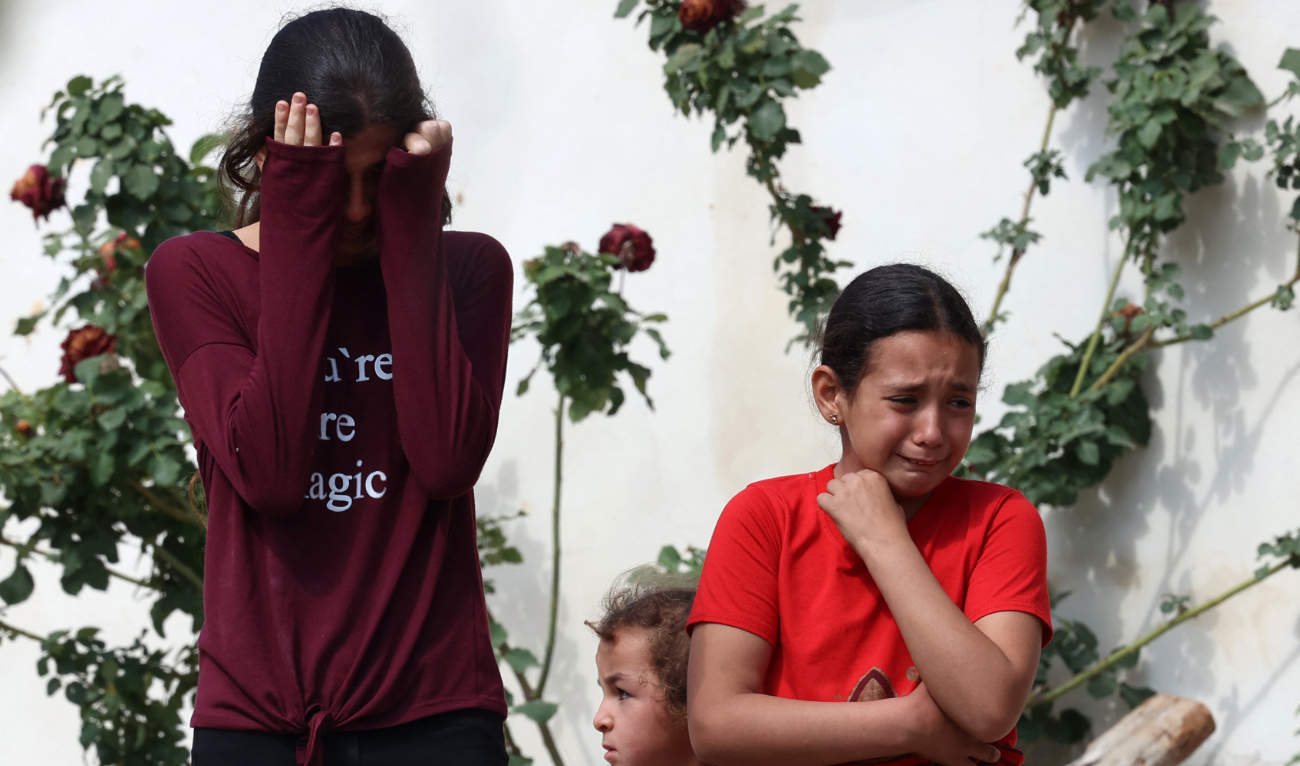 Palestinian girls cry as Israeli army excavators demolish buildings in the village of Qibyah, north west of Ramallah, in the occupied West Bank. (File/AFP)