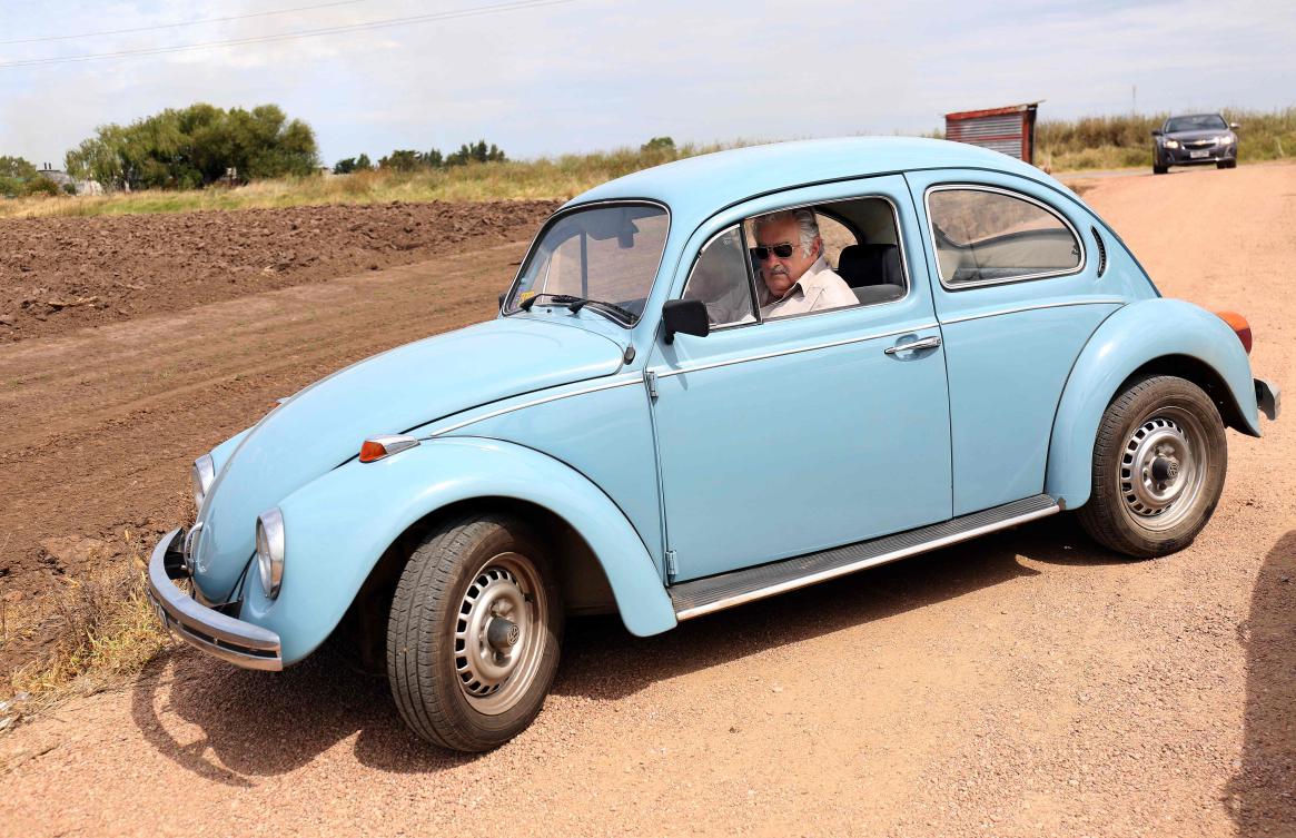 Uruguay’s former President Jose Mujica drives a 1987 Volkswagen Beetle, which he considered as his prized possession, near his house after leaving the presidency, March 1, 2015. (File/AFP)