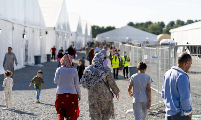 Afghan refugees walk through an Afghan refugee camp at Joint Base McGuire Dix Lakehurst, NJ. (AP/File)