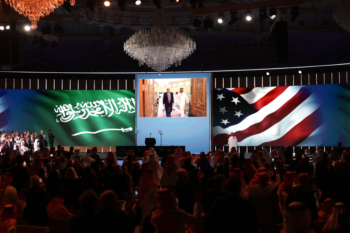 People look to a giant screen as US President Donald Trump and Saudi Crown Prince Mohammed bin Salman arrive for the Saudi-US investment forum at the King Abdul Aziz International Conference Center in Riyadh on May 13, 2025. The one-day investment summit highlighted the Kingdom’s growing appeal to US industries and the potential for strengthening ties aligned with Vision 2030. (AFP)