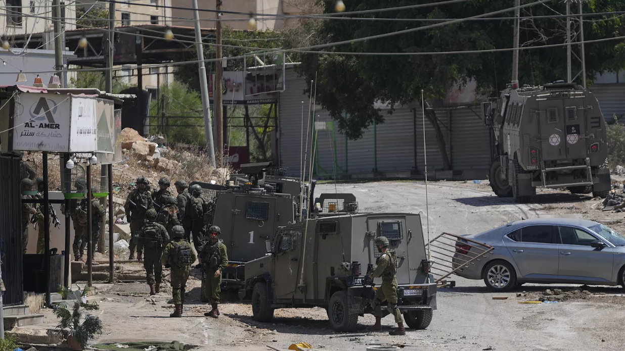 Members of Israeli forces patrol a street during a military operation in the West Bank refugee camp of Al-Faraa. (AP/File)