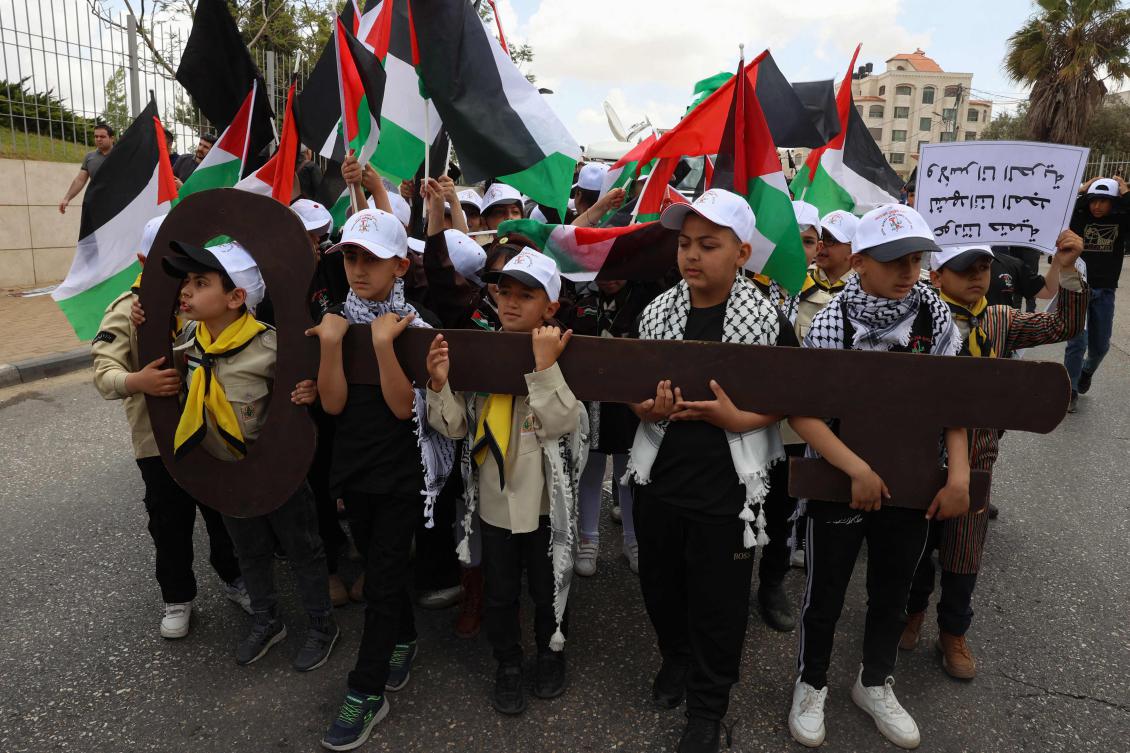 Palestinian children hold up a cutout symbolising the key to houses left by Palestinians in 1948 as they take part in a rally to commemorate the 77th anniversary of the "Nakba" in the city of Ramallah in the occupied West Bank on May 14, 2025. (Photo by Zain JAAFAR / AFP)