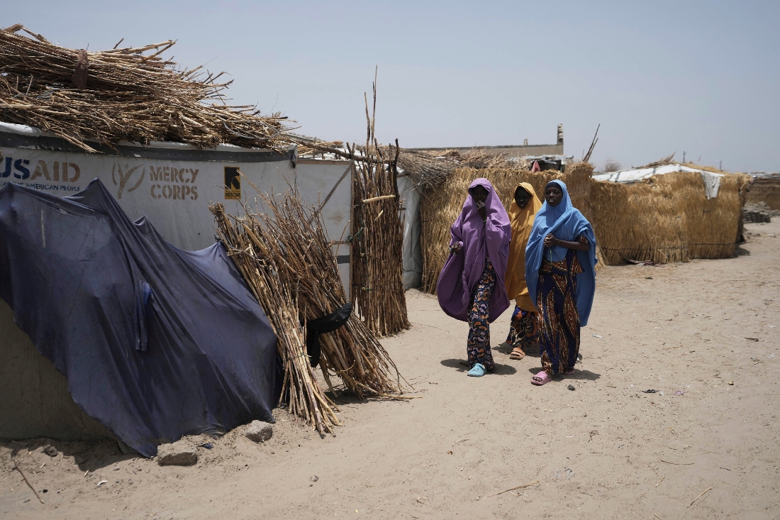 Women walk past USAID tent in Dikwa, Nigeria. (AP)