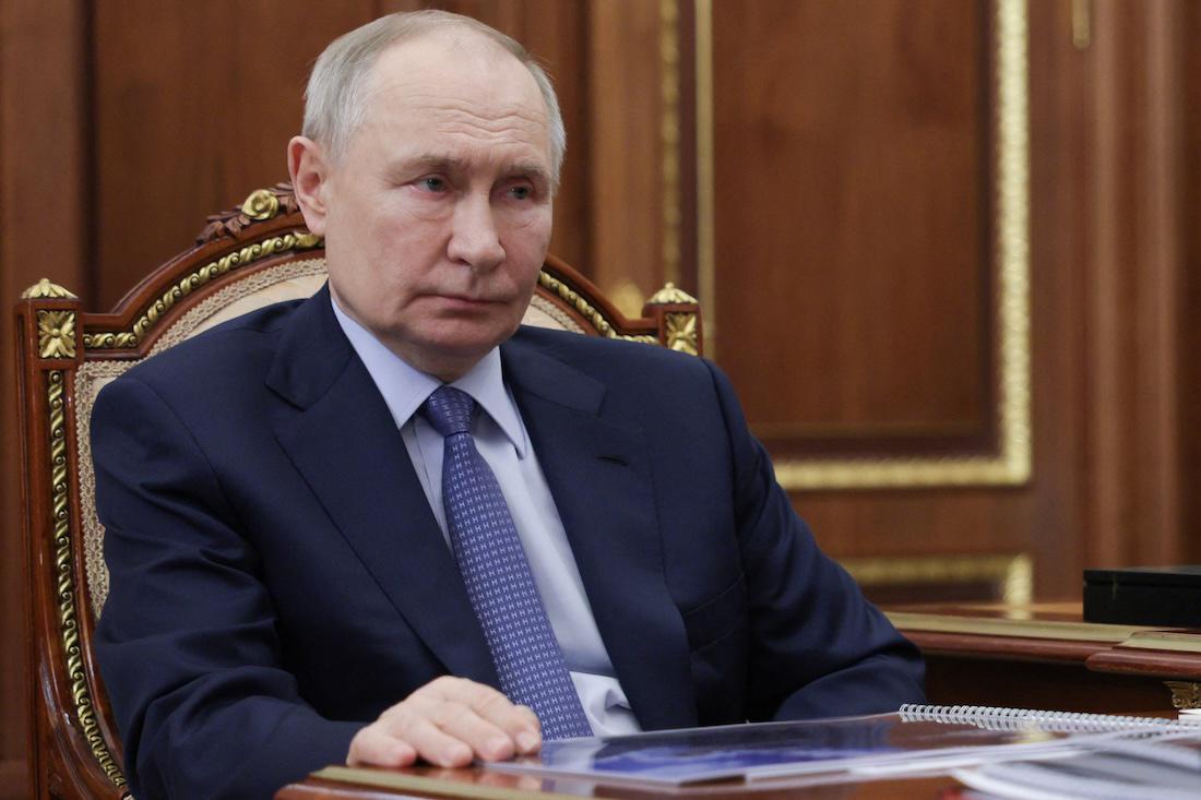 In this pool photograph distributed by the Russian state agency Sputnik, Russia's President Vladimir Putin meets with Promsvyazbank CEO at the Kremlin. (File/AFP)