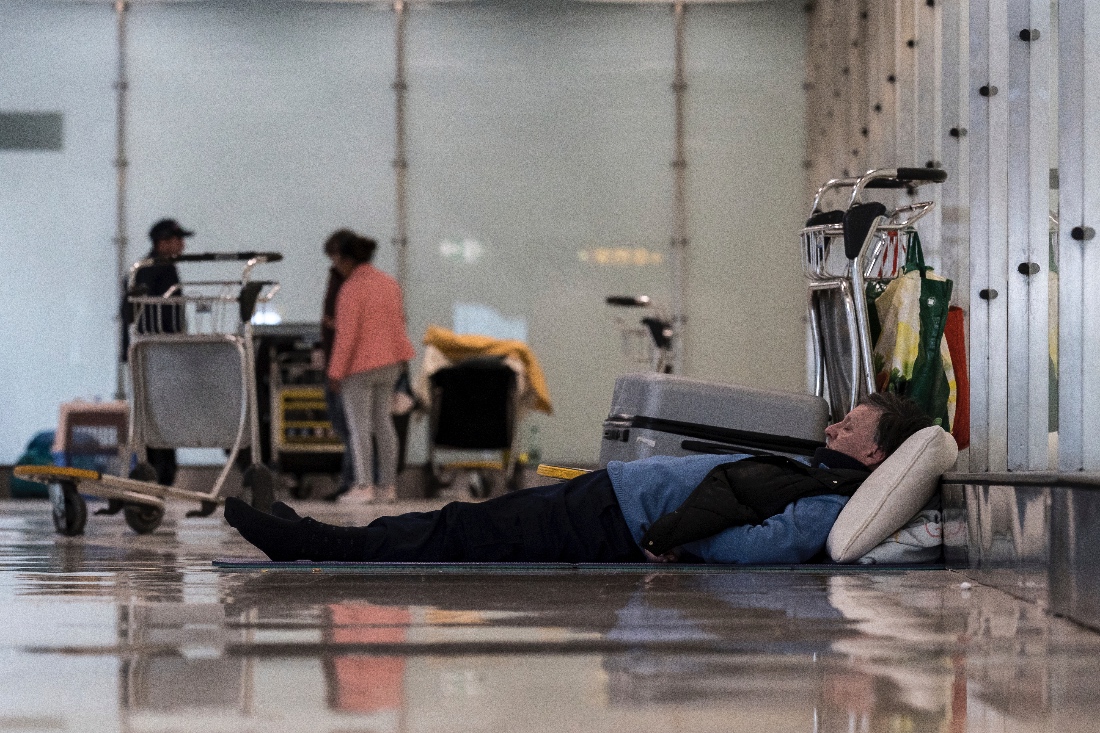 A homeless man lying on the floor of Madrid airport. (AP)