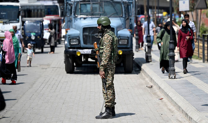 An Indian paramilitary soldier stands guard along a street in Srinagar on May 14, 2025. (AFP/File Photo)
