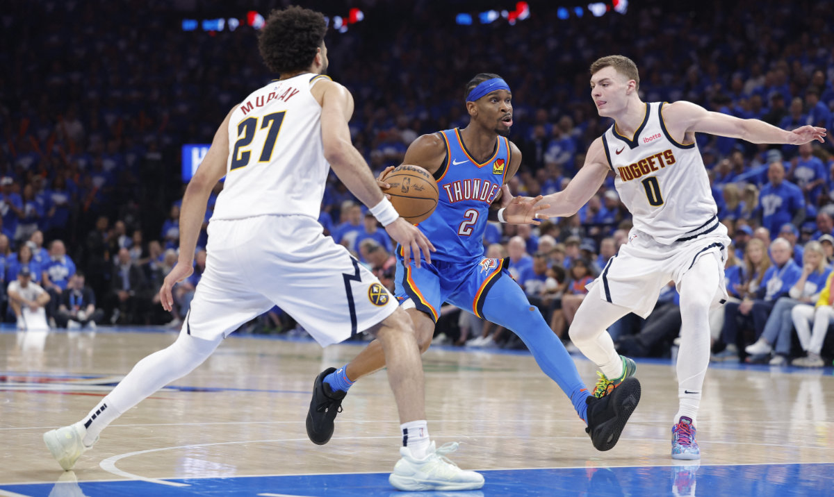 Oklahoma City Thunder guard Shai Gilgeous-Alexander (2) drives to the basket between Denver Nuggets guard Jamal Murray (27) and guard Christian Braun (0) in the second half of game seven of the second round for the 2025 NBA Playoffs at Paycom Center. (Reuters)