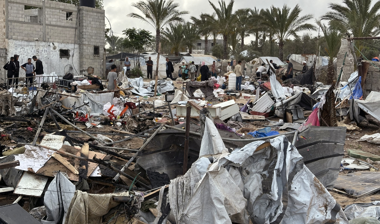 Palestinians inspect the debris at the site of Israeli strikes on a displacement tent camp, in the Mawasi area west of Khan Yunis in the southern Gaza Strip on May 18, 2025. (AFP/File)