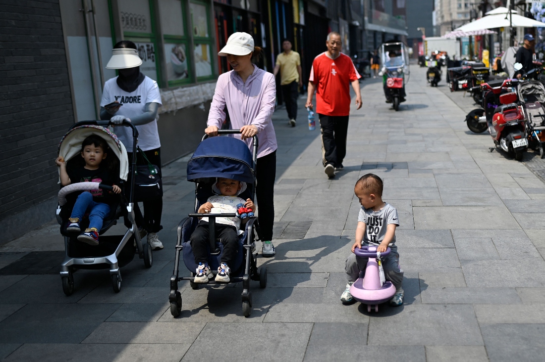 Mothers pushing their baby carriages in Beijing, China. (AFP)
