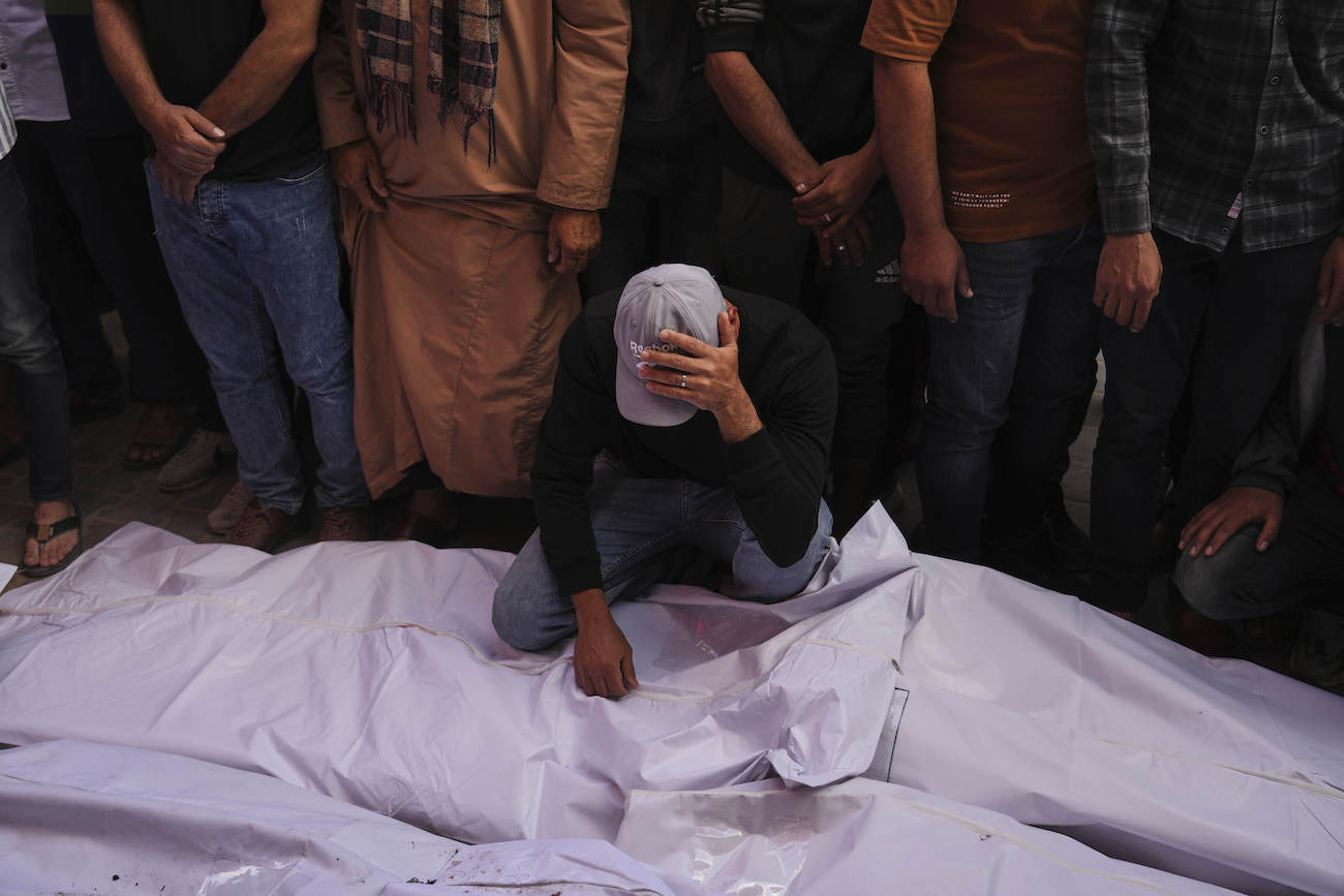 Palestinian mourn relatives who were killed in Israeli army airstrike on the Gaza Strip, at the morgue of Al-Aqsa Hospital in Deir al-Balah, Gaza, May 20, 2025. (AP)