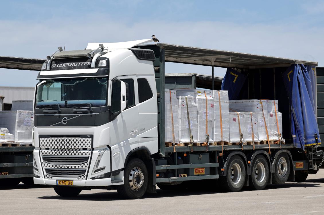 Trucks carrying aid wait to enter the Gaza Strip from the Israeli Kerem Shalom crossing, May 20, 2025. (AFP)