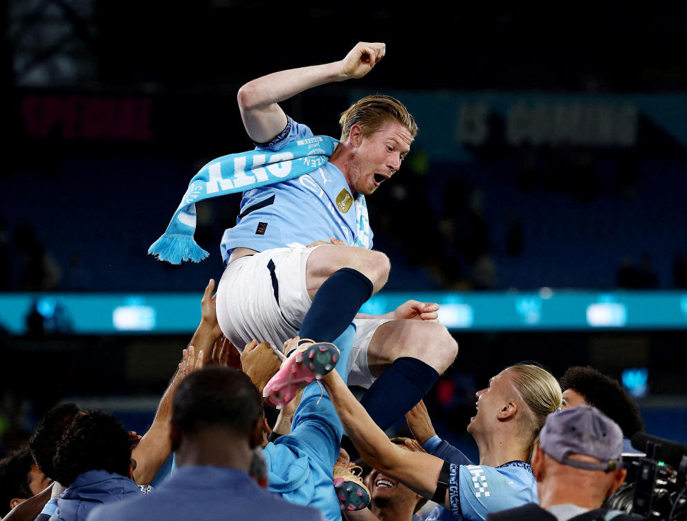Manchester City’s Kevin De Bruyne is thrown in the air by teammates during a tribute after the match as he plays his last match at the Etihad Stadium. (Action Images via Reuters)