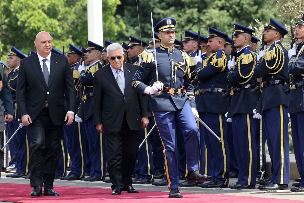 Lebanese President Joseph Aoun walks alongside Palestinian Authority President Mahmoud Abbas as they review an honor guard at the Presidential Palace in Baabda, May 21, 2025. (AFP)