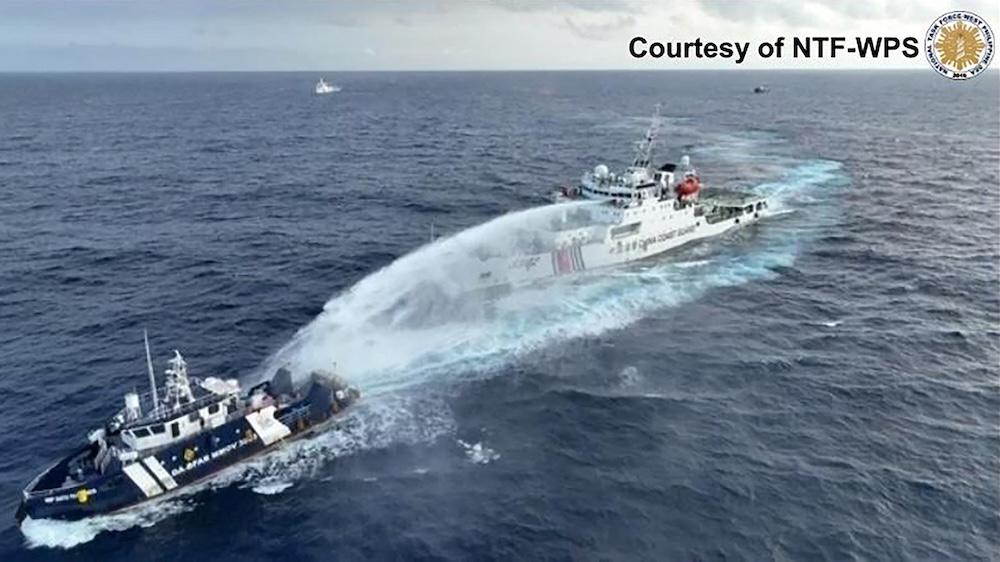 China and the Philippines has a long-running maritime standoff in contested waters of the South China Sea. Above, a China Coast Guard ship, right, deploys water cannon at the Philippine survey vessel BRP Datu Pagbuaya on Dec. 4, 2024. (NTF-WPS/AFP file photo)