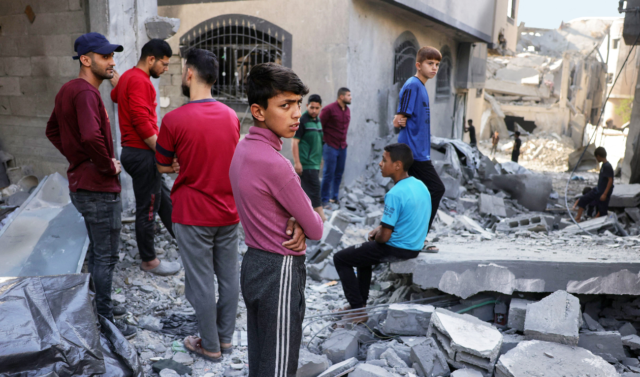 Palestinians check the devastation after Israeli bombing destroyed a home in Jabalia’s Saftawi neighborhood in the northern Gaza Strip on Thursday. (AFP)