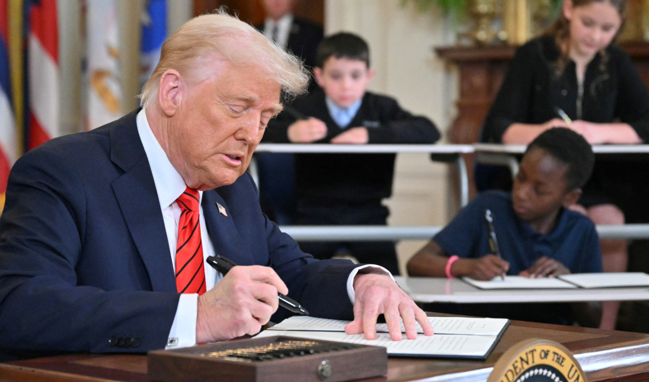 US President Donald Trump signs an executive order aimed at shutting down the Education Department in the East Room of the White house in Washington, DC, on March 20, 2025. (AFP/File)