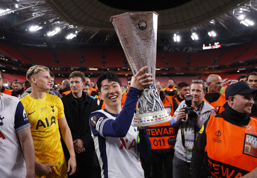 Tottenham Hotspur’s Son Heung-min celebrates with the trophy after winning the Europa League Final. (Reuters)